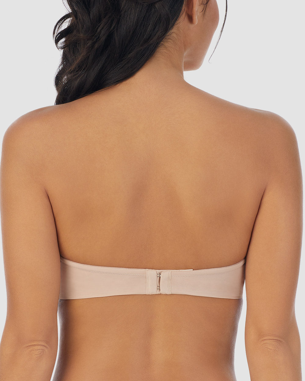 A lady wearing champagne Sleek Micro Strapless Plunge