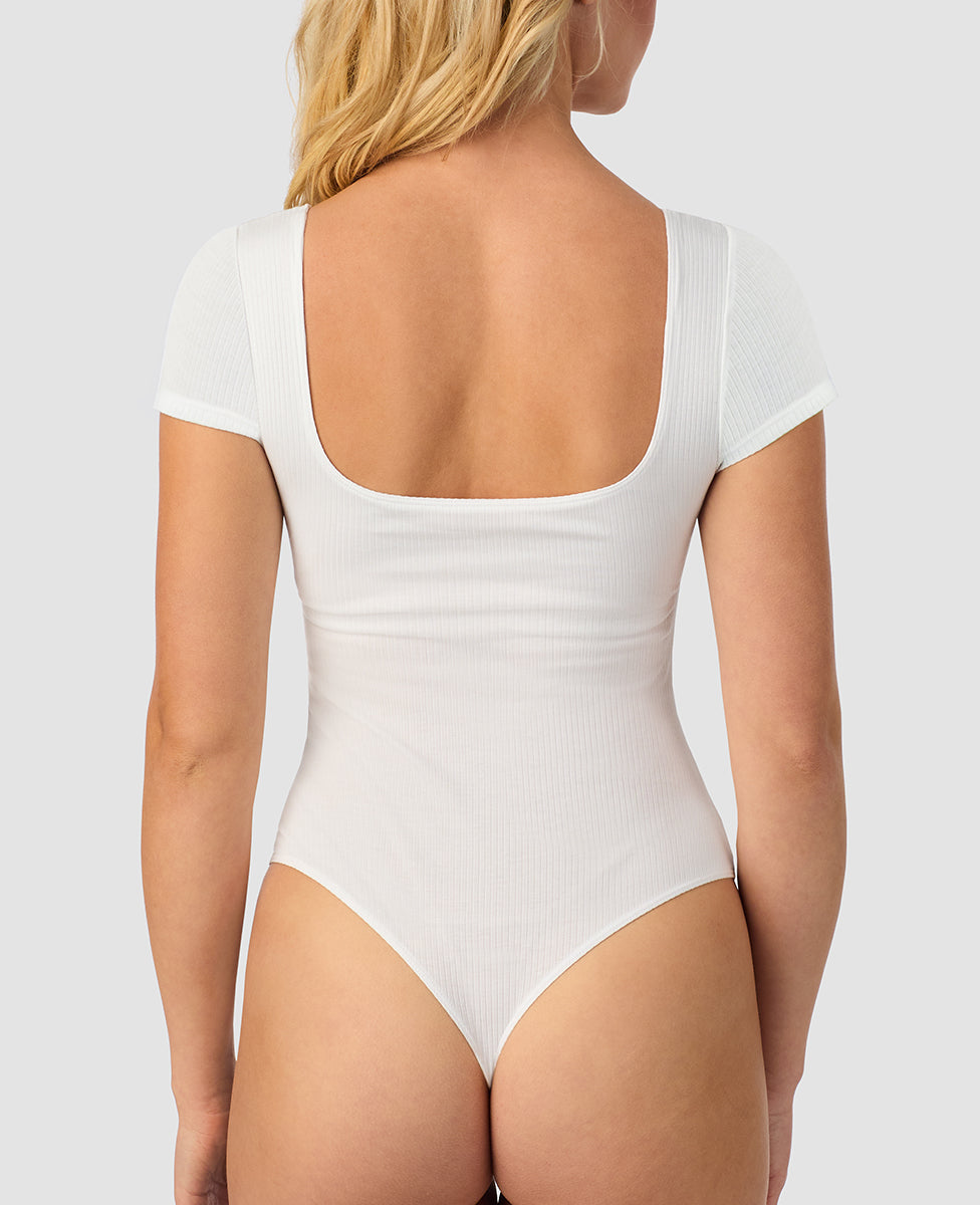 A lady wearing white Cabana Cotton Rib Bodysuit