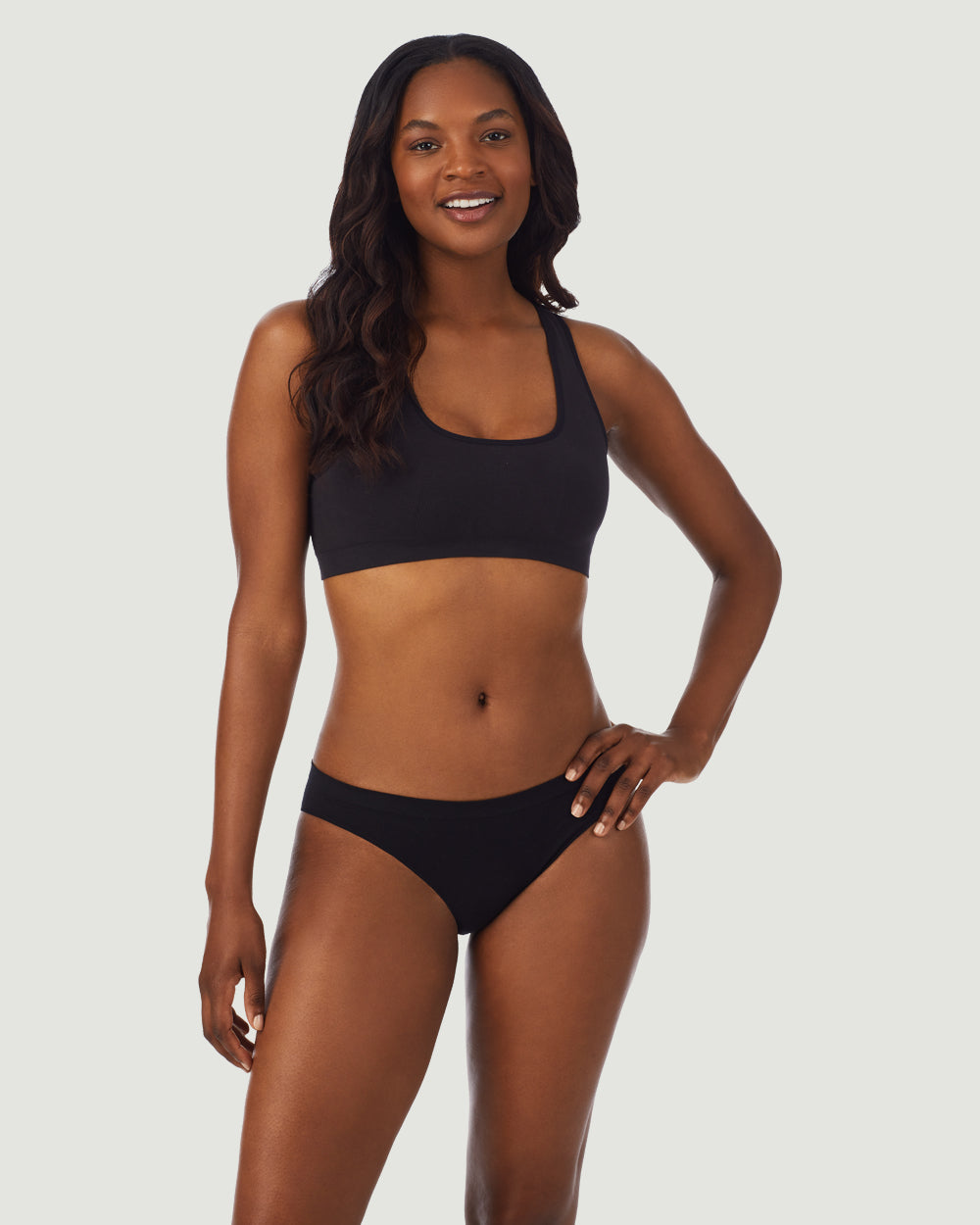 A lady wearing black cabana cotton seamless easy tank bralette