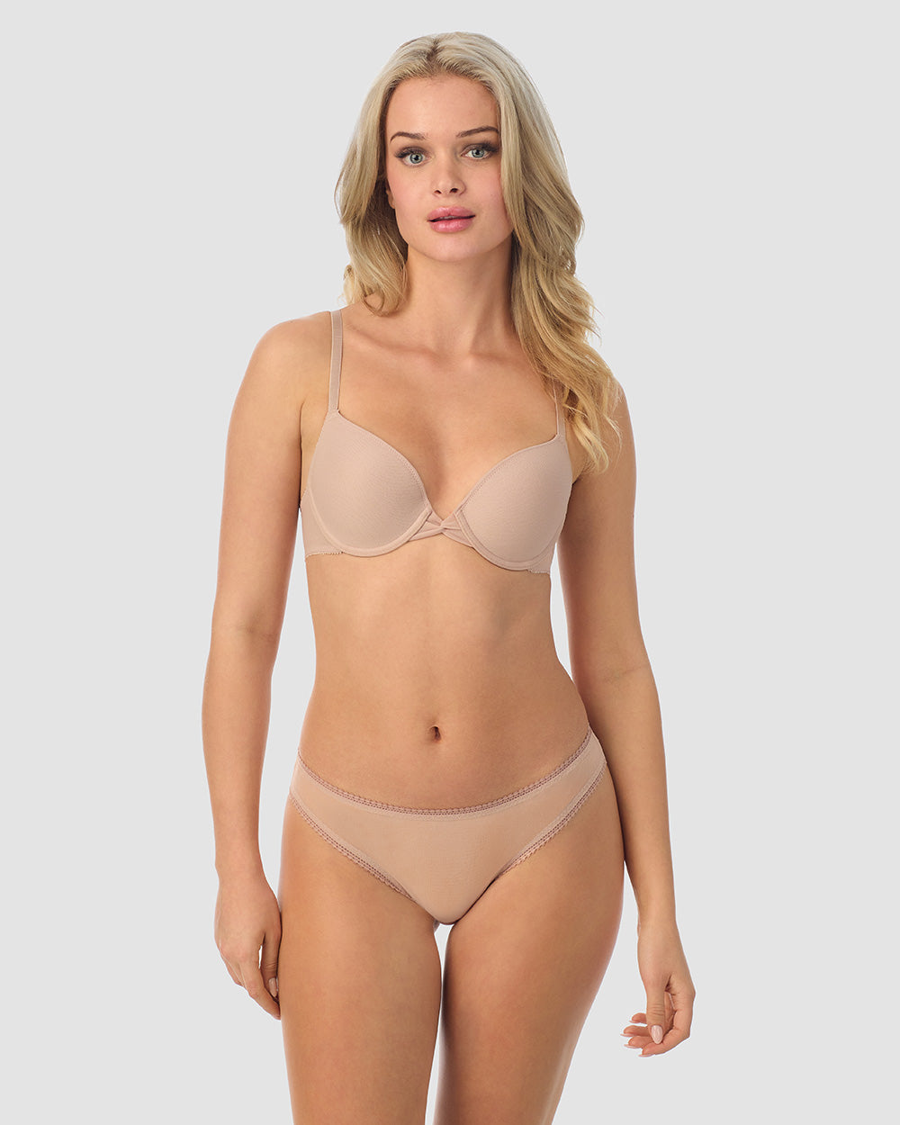 A lady wearing champagne gossamer mesh bump-it-up bra.