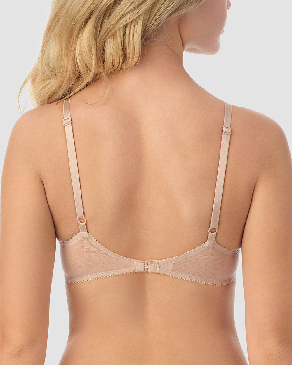 A lady wearing champagne gossamer mesh bump-it-up bra.
