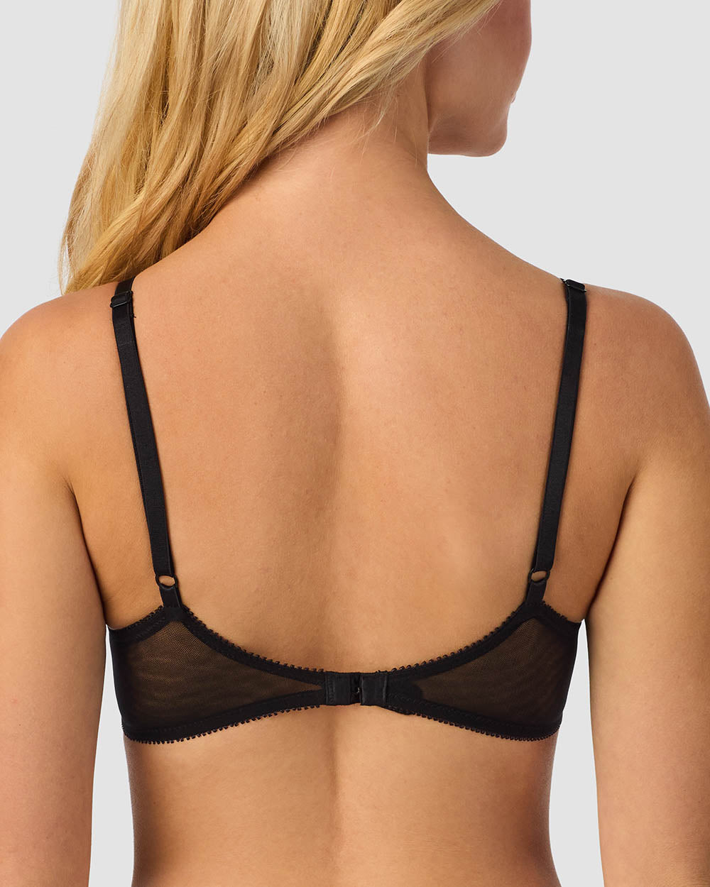 A lady wearing a black gossamer mesh bump-it-up-bra.