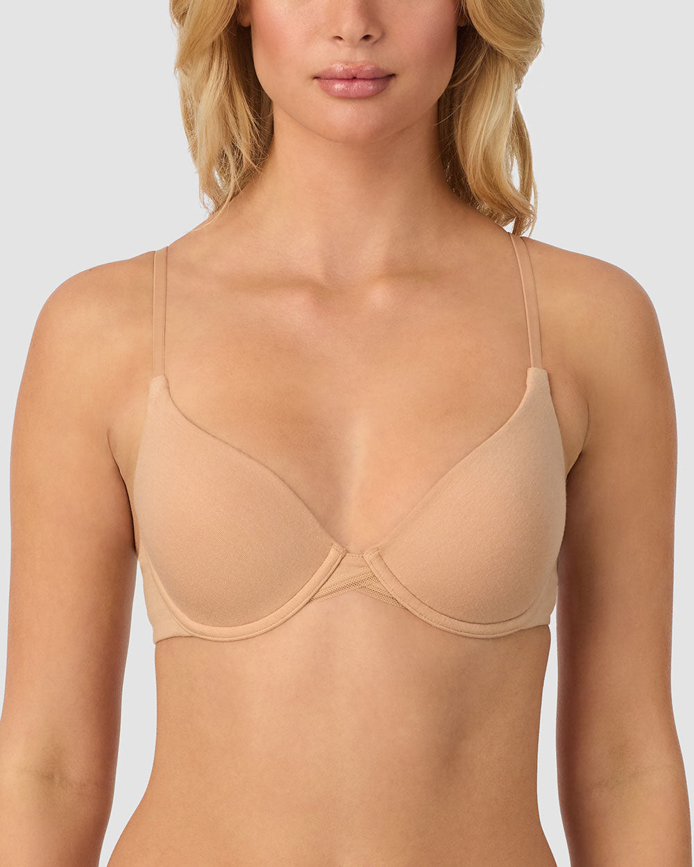 A lady wearing champagne cabana cotton convertible t-shirt bra.