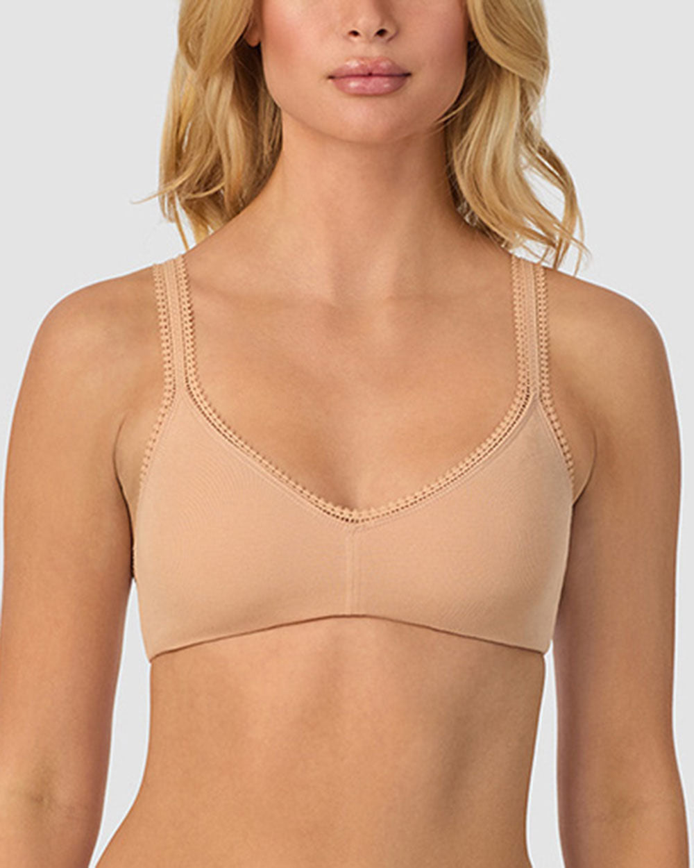 A lady wearing champagne cabana cotton bralette.