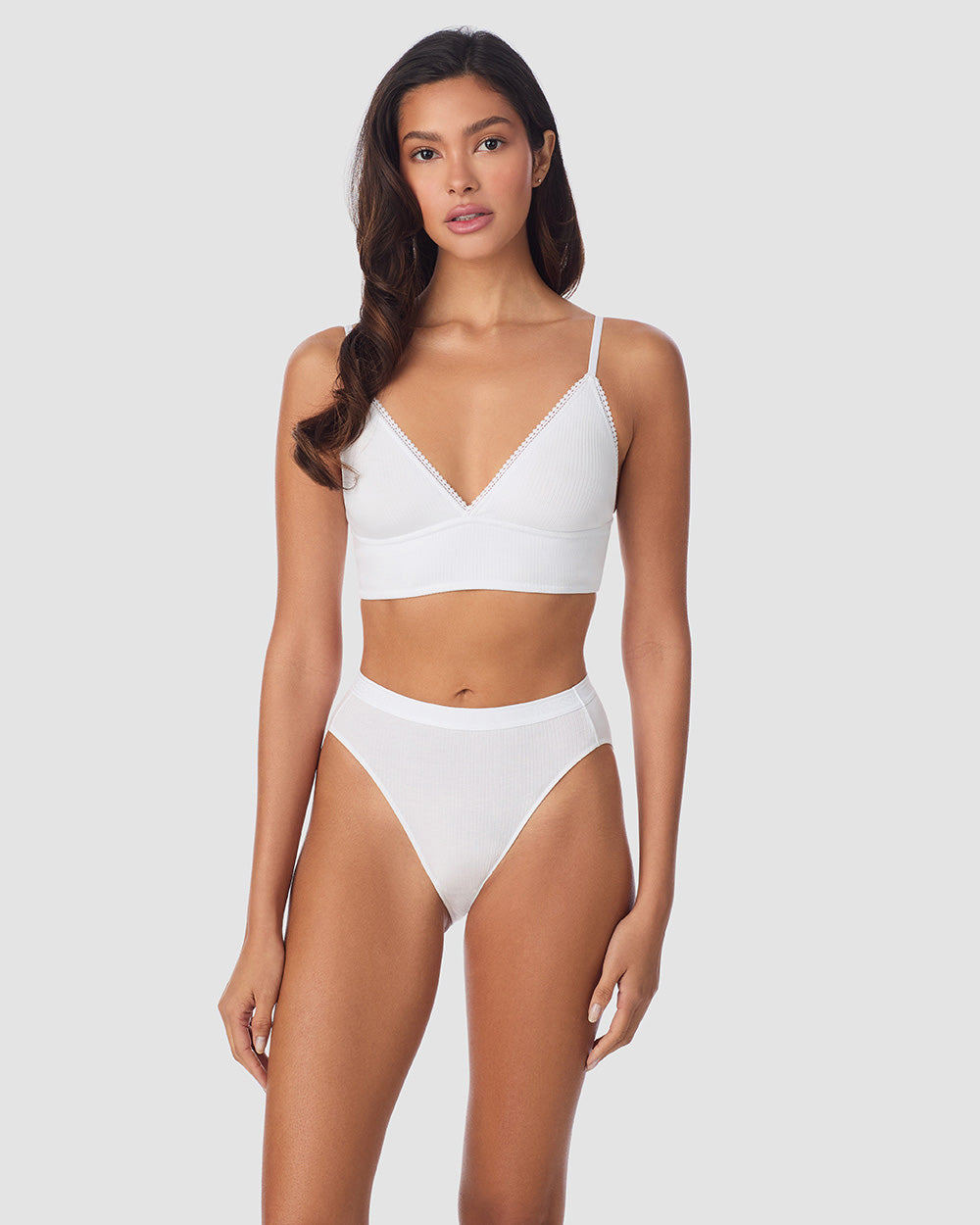 A Lady Wearing Cabana Cotton Rib Longline Triangle Bralette - White posing front standing view