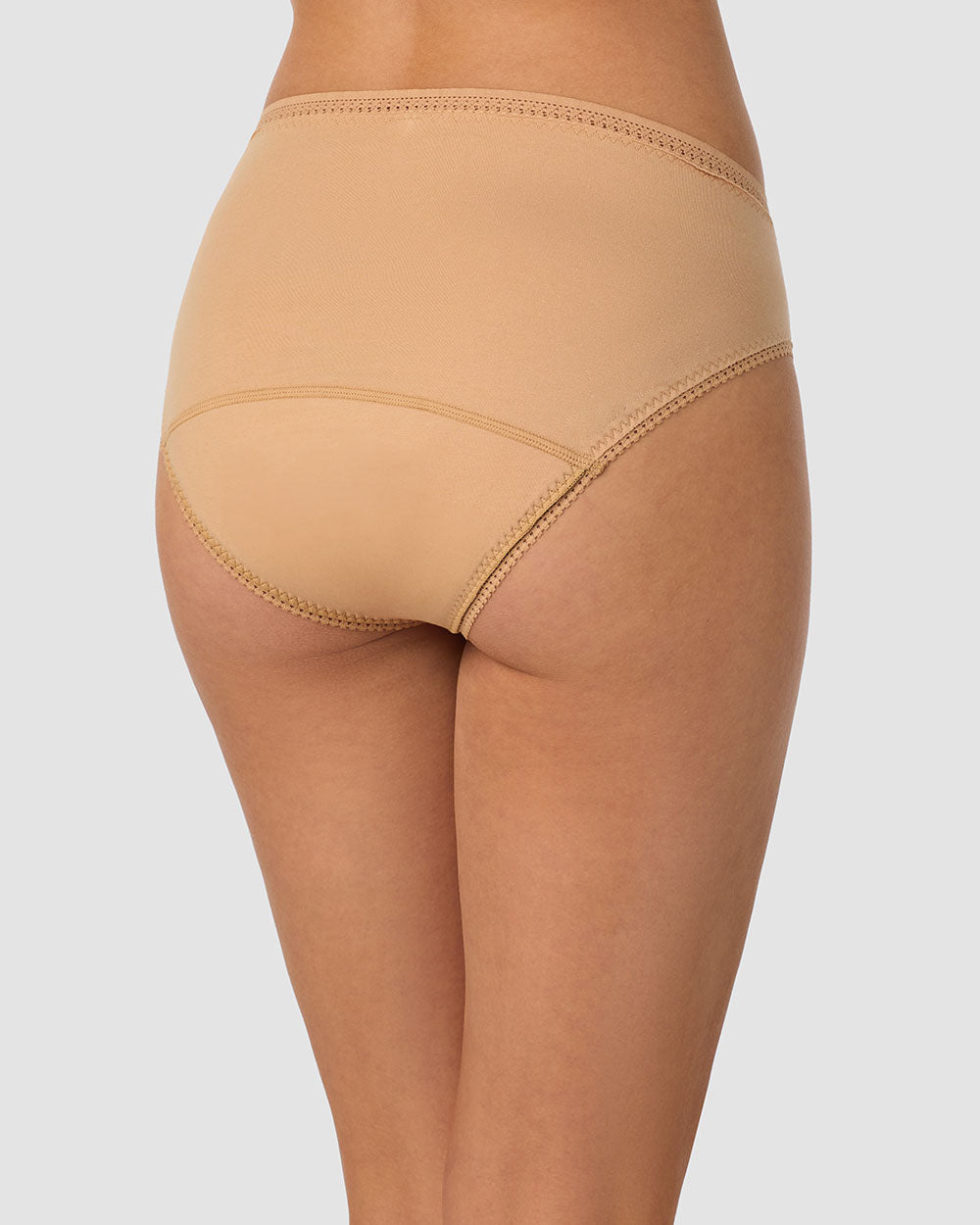 A lady wearing champagne Cabana Cotton Leak Proof Hi Cut Brief