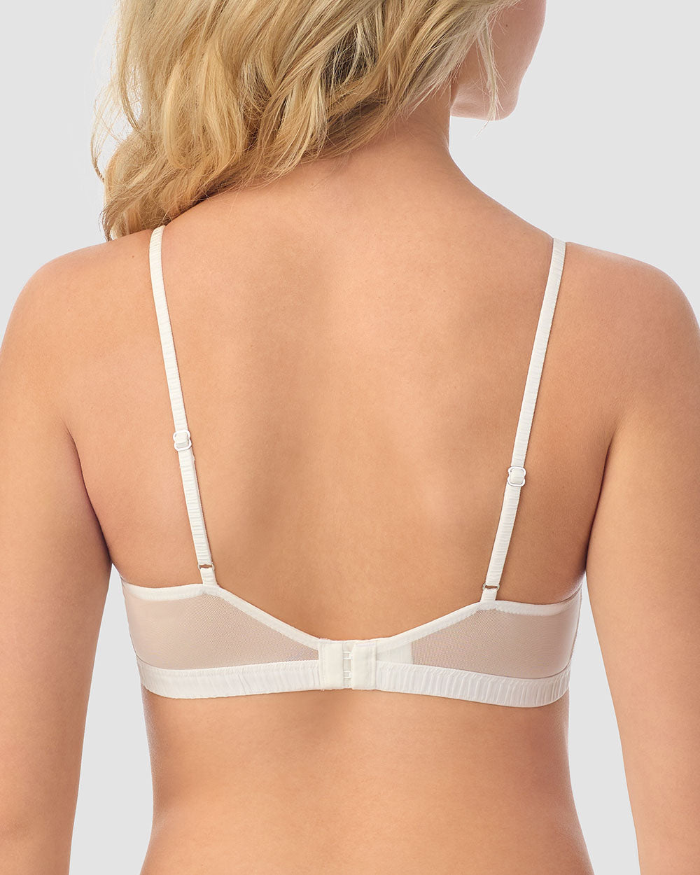 A lady wearing white Luxe Lace Bralette