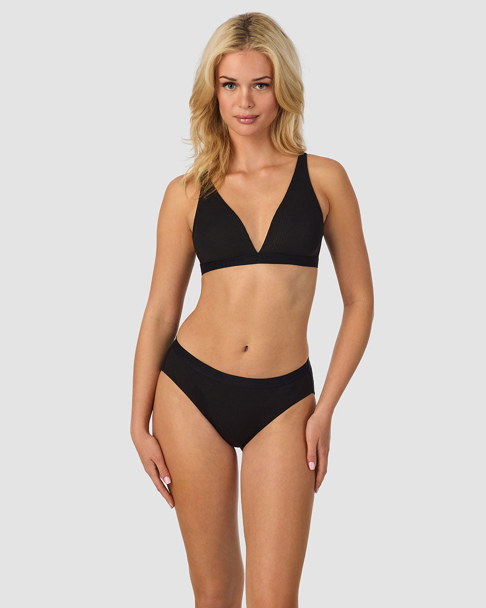 A lady wearing black Cabana Cotton Rib Plunge Bralette