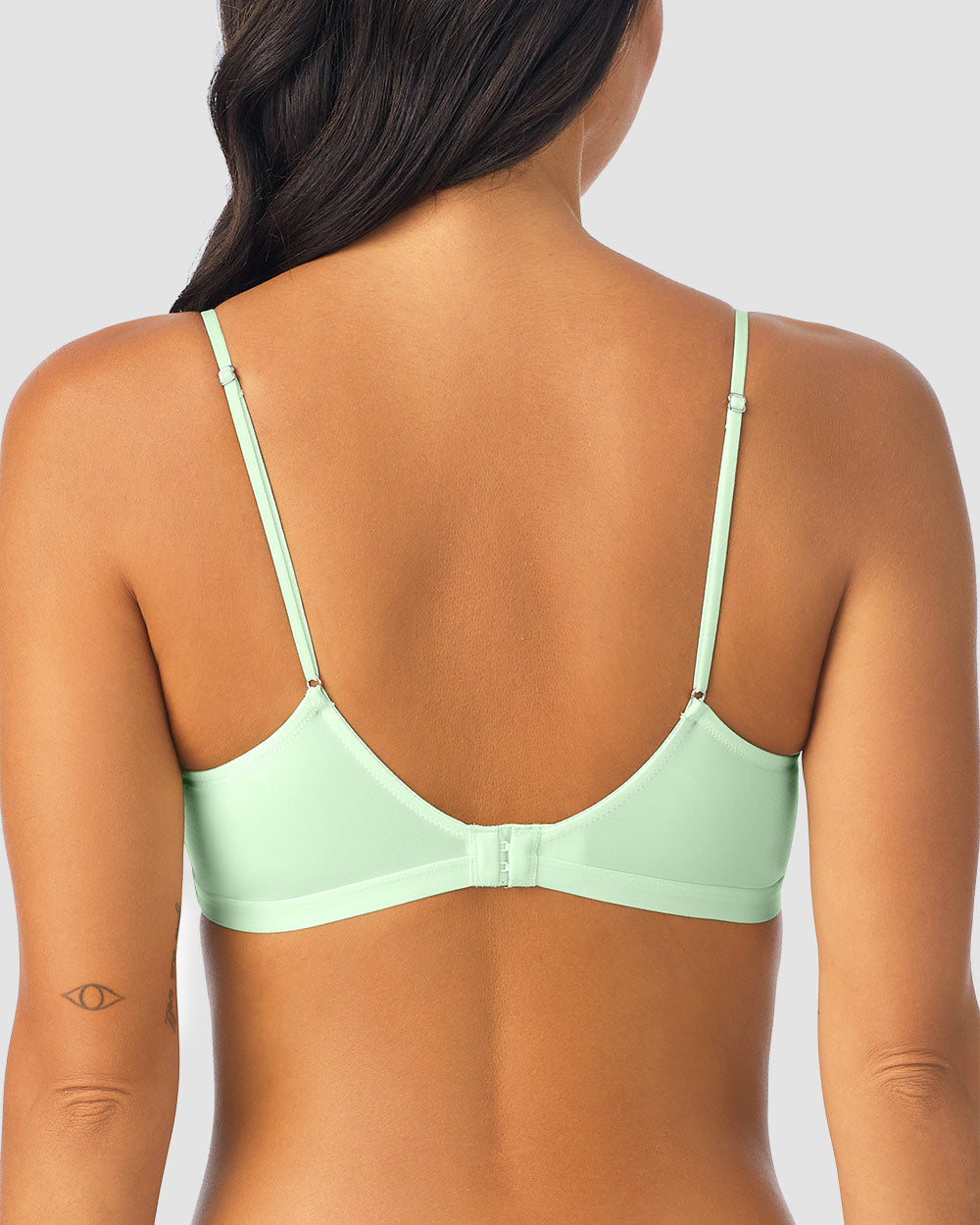 A lady wearing green Next To Nothing Micro Wireless Bra