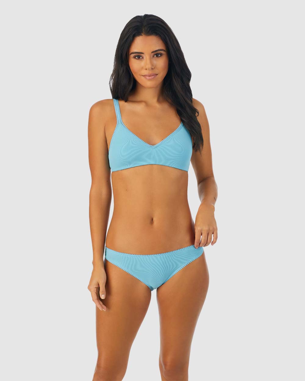 A lady wearing turquoise sea cabana cotton bralette.