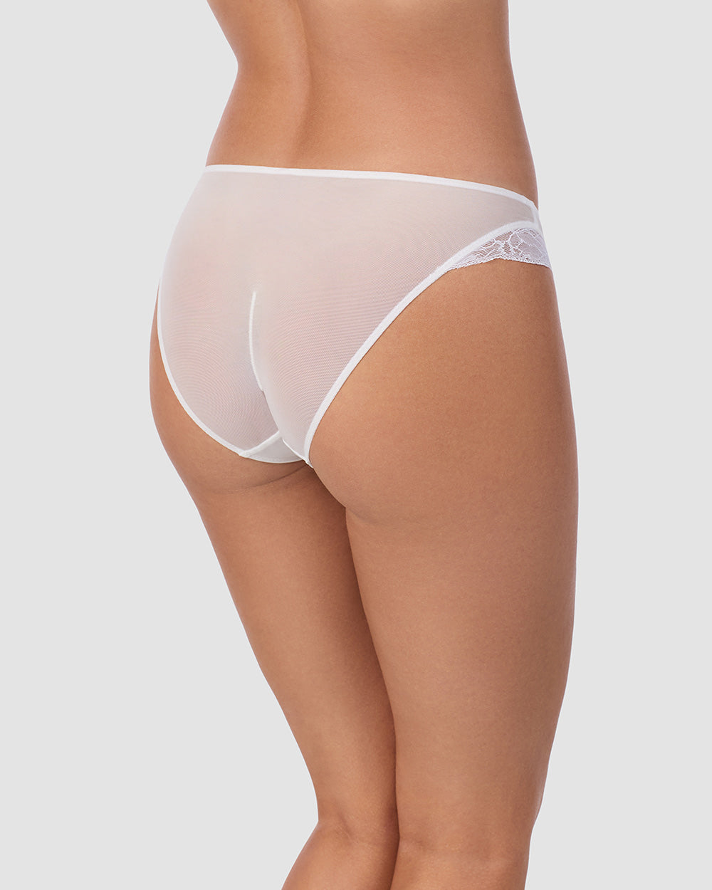 A lady wearing Luxe Lace Bikini in White