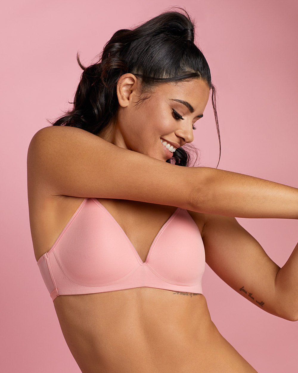 A lady wearing pink Next To Nothing Micro Wireless Bra