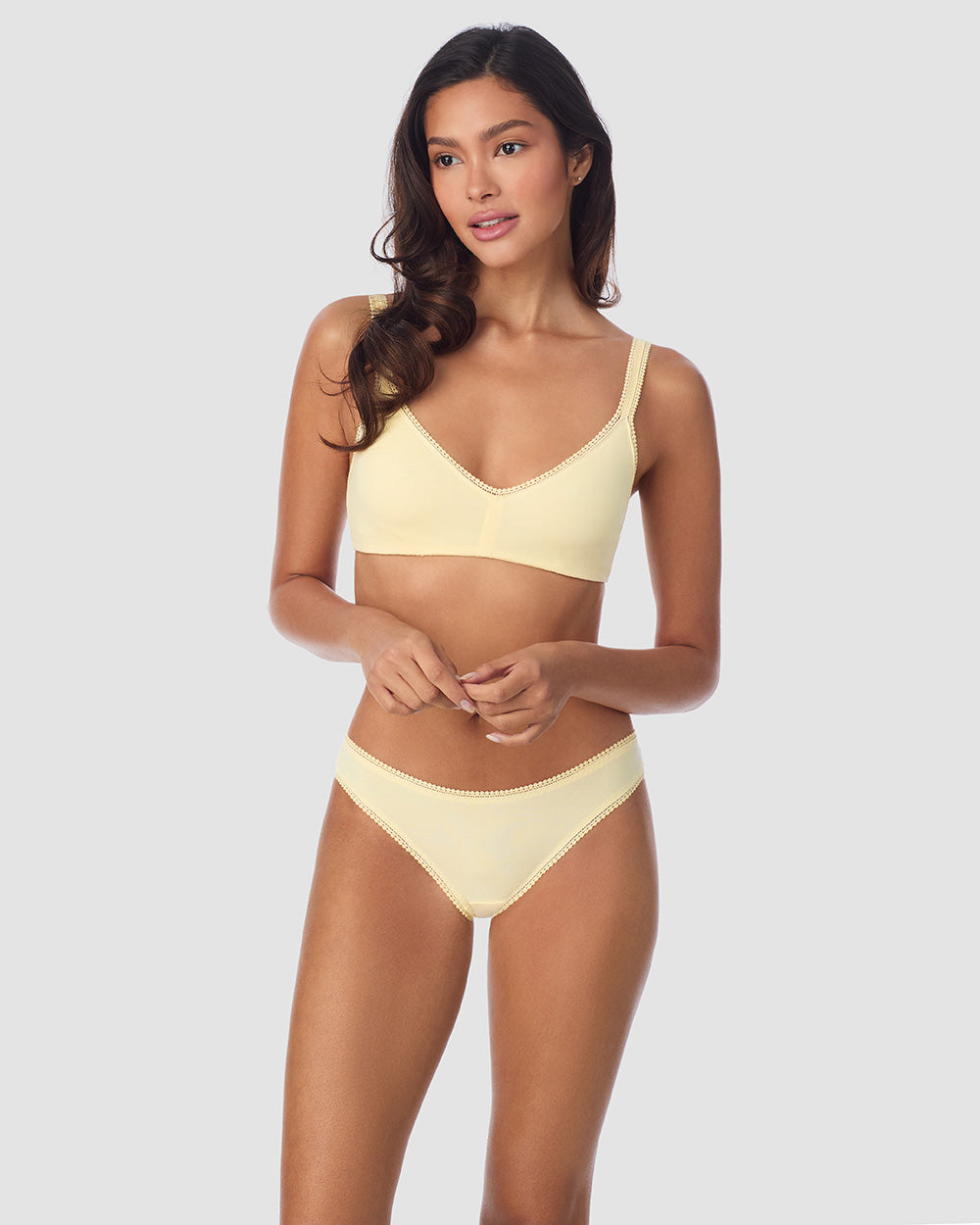 A Lady Wearing Cabana Cotton Bralette - Banana Cream facing front with a standing pose