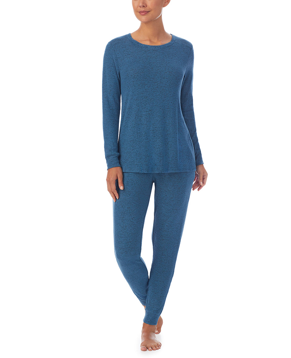 A lady wearing Purist Teal Long Sleeve Crew Neck Top