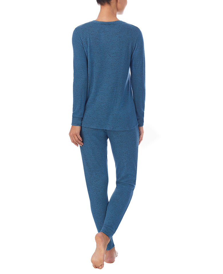 A lady wearing Purist Teal Long Sleeve Crew Neck Top